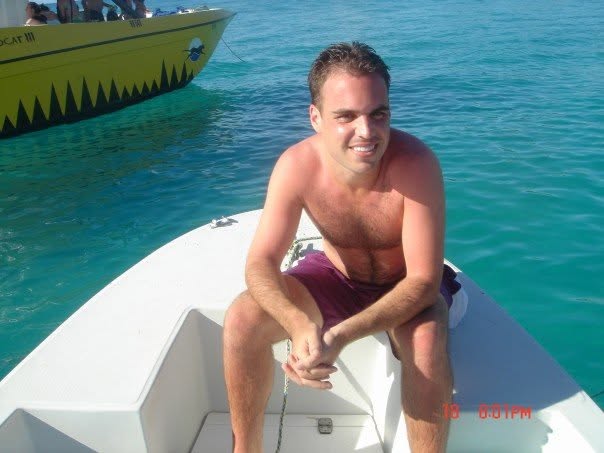 Chris Clayton on a boat in the clear water off Barbados